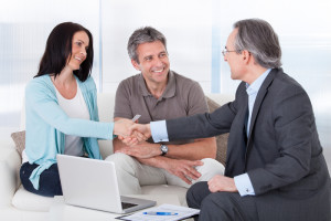 Consultant Shaking Hand With Happy Woman